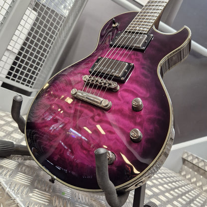 Pre-Owned Schecter Hellraiser Hybrid Solo-II Electric - Transparent Purple Burst A purple and magenta flame-glazed electric guitar with chrome hardware, resting on a black stand on a metal diamond plate floor.