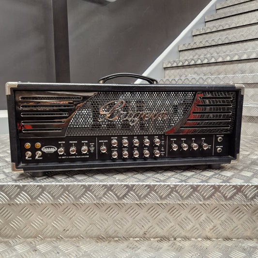 Pre-Owned Bugera 333XL Infinium 120w Electric Amplifer Head A Rogers 100W guitar amplifier head sitting on a diamond plate metal staircase. The amplifier is black with chrome/silver controls, a chrome front grille, and red accents on the side.