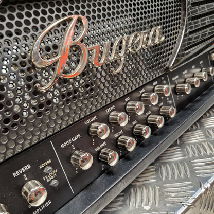 Pre-Owned Bugera 333XL Infinium 120w Electric Amplifer Head Close-up of a Bugga guitar amplifier head with chrome knobs, a black perforated grille, and a silver diamond plate surface below.