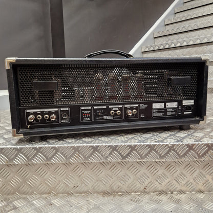 Pre-Owned Bugera 333XL Infinium 120w Electric Amplifer Head A black Fender guitar amplifier head with a metal mesh front grille and control panel, resting on a diamond plate metal staircase.