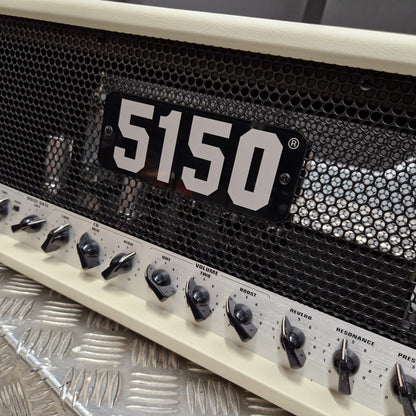 Pre-Owned EVH 5150 Iconic 80W Electric Amplifier Head Close-up of a 5150 guitar amplifier head with a cream-colored faceplate, black mesh grille, and black control knobs on a silver diamond plate floor.