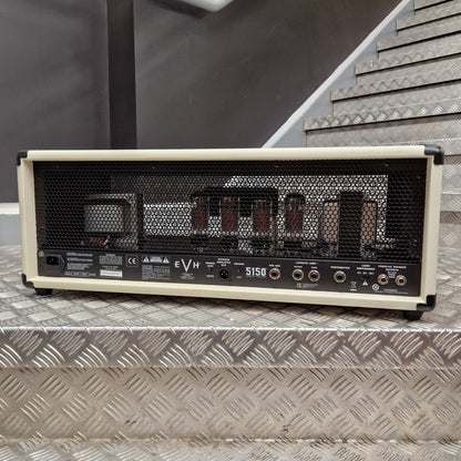 Pre-Owned EVH 5150 Iconic 80W Electric Amplifier Head A vintage-style tube amplifier head, model 5150, shown from the rear. It features a cream-colored frame, a black mesh grille, and multiple vacuum tubes visible inside, resting on a silver diamond-plate metal staircase.