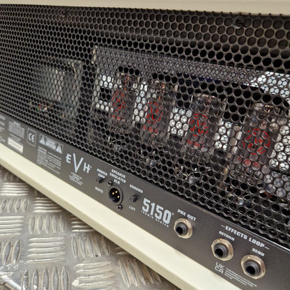 Pre-Owned EVH 5150 Iconic 80W Electric Amplifier Head Close-up of the rear panel of an EVH S150 effects guitar amplifier, showing the black honeycomb vent, internal tubes, red LED numbers, and input/output jacks on a cream-colored body.