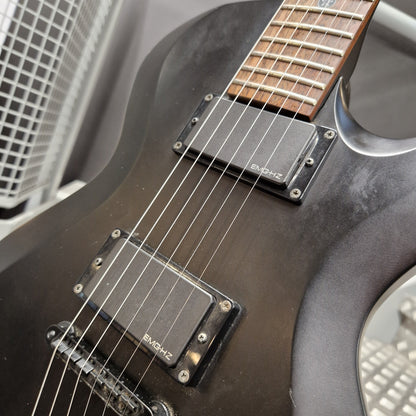 Pre-Owned Cort EVL-Z4 Electric - Satin Black Close-up of a black electric guitar body with two black humbucker pickups, silver screws, and part of the fretboard visible.