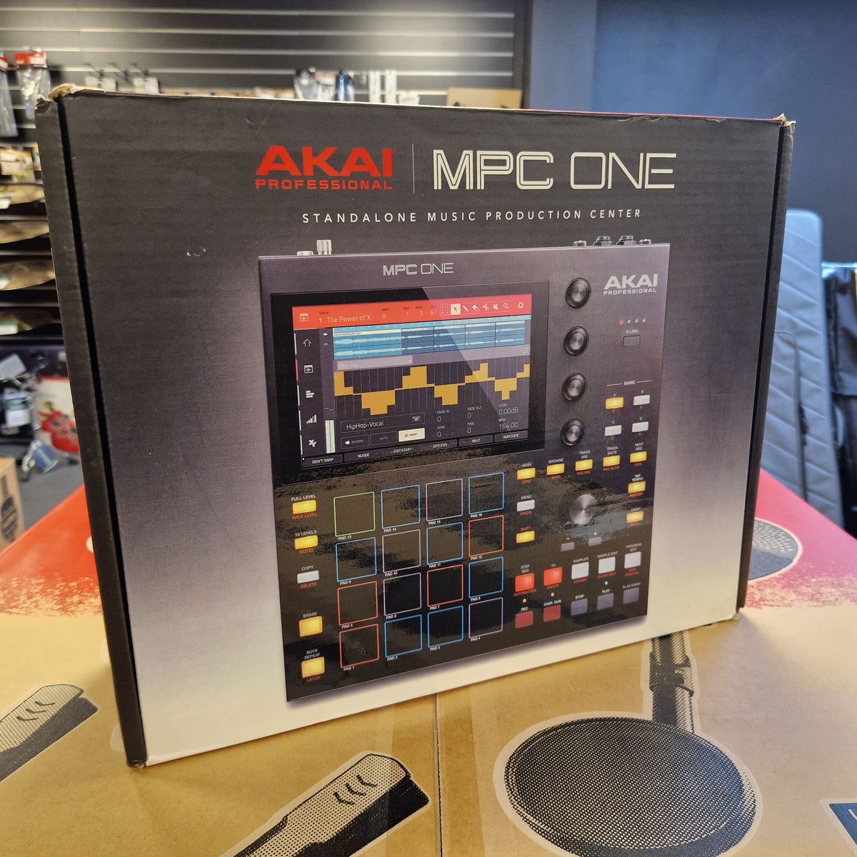 Pre-Owned Akai MPC ONE Standalone Music Production Centre AKAI MPC One Standalone Music Production Center box, showing the product packaging with a graphic of the black electronic controller on a white and black background.
