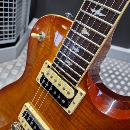 Pre-Owned PRS SE Bernie Marsden Signature Electric - Vintage Sunburst Close-up of a sunburst electric guitar body and fretboard with gold hardware, showing part of the neck and pickups.