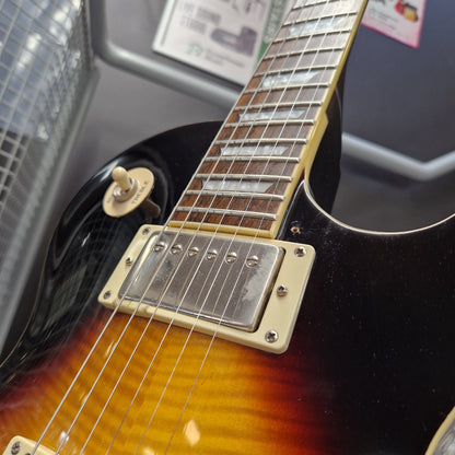 Pre-Owned Epiphone Les Paul Standard Pro Electric - Vintage Sunburst Close-up of a sunburst electric guitar body showing the black, brown, and amber gradient finish, cream humbucker pickups, and part of the fretboard.