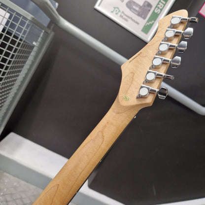 Pre-Owned Aria Pro II 714 Series Electric - Sunburst Close-up of the headstock and neck of an electric guitar, showing six silver tuning pegs, a light natural wood neck, and a small green circular logo decal on a dark display background.