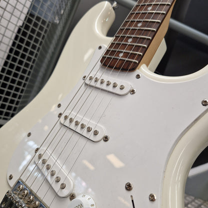 Pre-Owned Squier Bullet Stratocaster Electric - Arctic White Close-up of a white electric guitar body with dual humbucker pickups, silver hardware, and part of the dark fretboard visible.