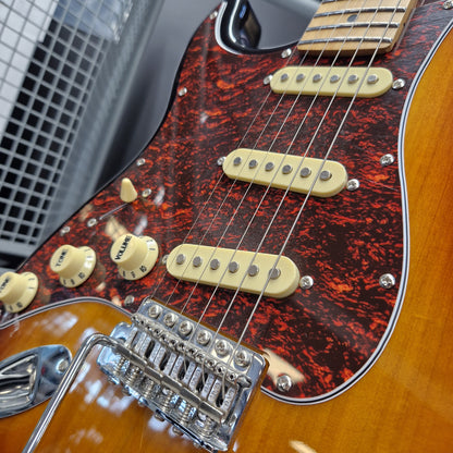 Pre-Owned Jet JS-300 Left-Handed Electric - Sunburst Close-up of a double-cutaway electric guitar body showing a red and black marbled tortoiseshell pickguard, cream-colored humbucker pickups, volume and tone knobs, and a chrome bridge over a warm orange-brown sunburst finish.