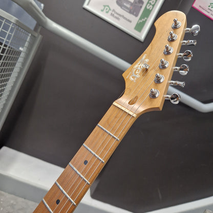 Pre-Owned Jet JS-300 Left-Handed Electric - Sunburst Close-up of a guitar headstock and upper fretboard, showing a natural wood finish, six silver tuning pegs, and inlays on a dark display background.
