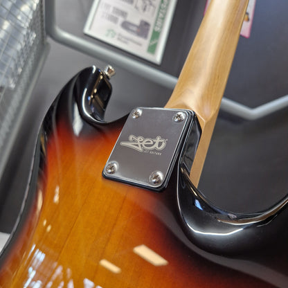 Pre-Owned Jet JS-300 Left-Handed Electric - Sunburst Close-up of a Fender electric guitar body showing the sunburst finish, black hardware, and the silver Fender logo plate on the backplate.