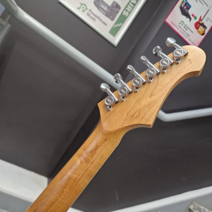 Pre-Owned Jet JS-300 Left-Handed Electric - Sunburst Close-up of the headstock of an electric guitar, showing a light natural wood finish and six silver tuning pegs, photographed indoors against a dark gray surface.