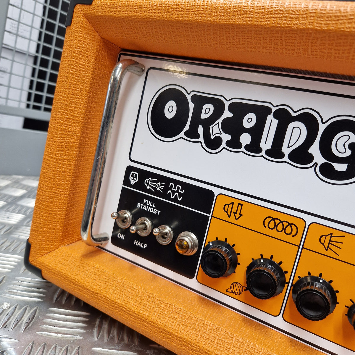 Pre-Owned Orange Rockerverb 50H MKIII Valve Electric Amplifier Head Close-up of an Orange amplifier head showing the front control panel with orange and white faceplate, black knobs, and silver switches on an orange fabric-wrapped cabinet.