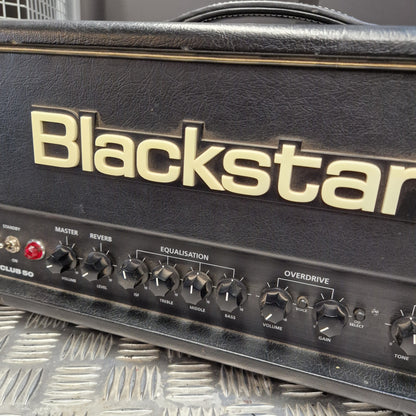Pre-Owned Blackstar HT Club 50 Electric All-Valve Amplifier Head Close-up of a Blackstar guitar amplifier head, showing the front control panel with knobs and the large Blackstar logo in gold on a black textured face.