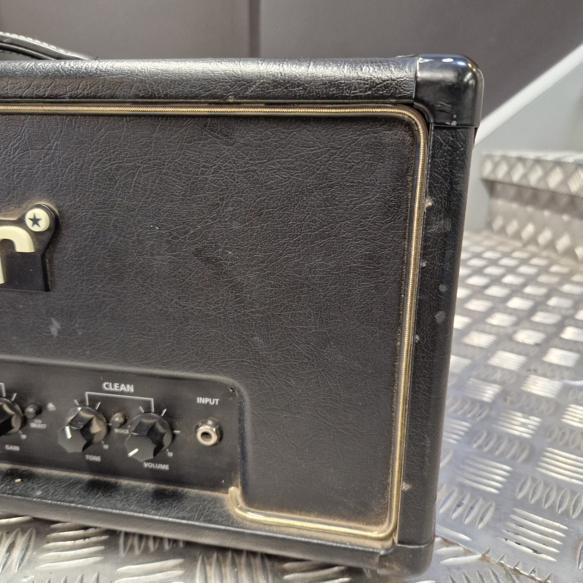Pre-Owned Blackstar HT Club 50 Electric All-Valve Amplifier Head Close-up of the side and rear control panel of a black guitar amplifier with gold trim, showing knobs and a textured black leather-like front.