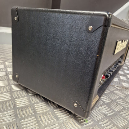 Pre-Owned Blackstar HT Club 50 Electric All-Valve Amplifier Head A black textured leather or vinyl guitar amplifier cabinet shown at an angle, resting on a silver diamond plate metal surface.