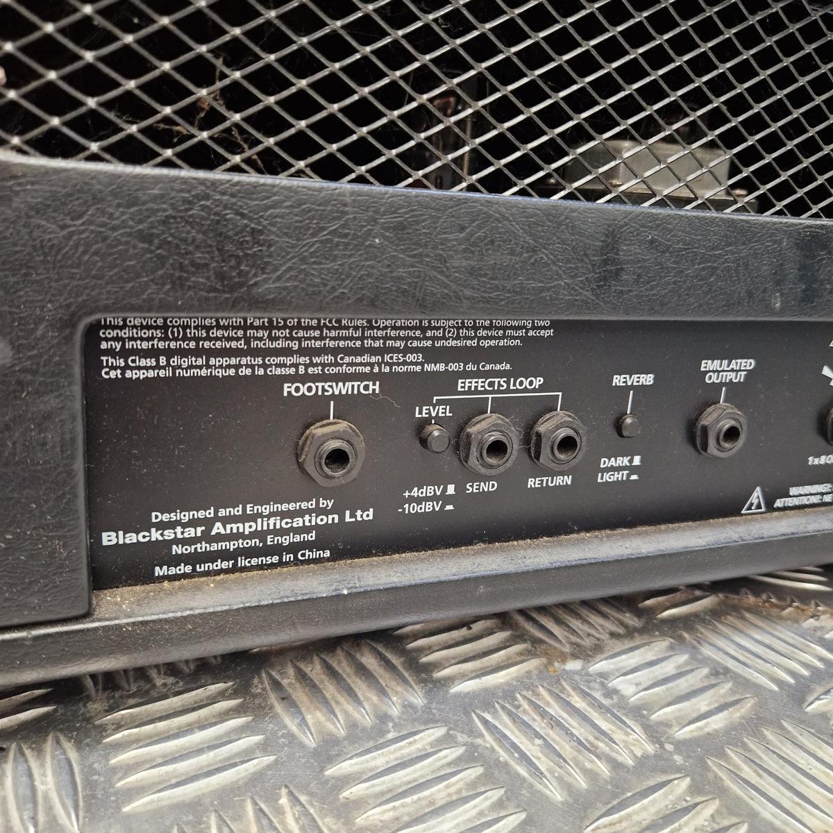 Pre-Owned Blackstar HT Club 50 Electric All-Valve Amplifier Head Close-up of a black amplifier control panel with input/output jacks, labels, and branding for a Blockster Amplification Ltd. model, photographed between textured metal grates.