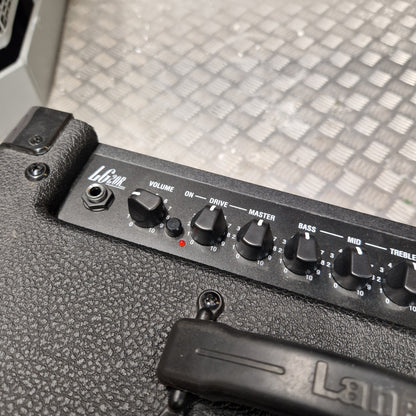 Pre-Owned Laney LG20R 20w Electric Guitar Combo Close-up of a black guitar amplifier control panel with knobs labeled Volume, Drive, Master, Bass, and Throttle, mounted on a textured black amplifier body.