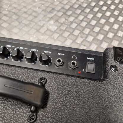 Pre-Owned Laney LG20R 20w Electric Guitar Combo Close-up of a black guitar amplifier control panel with knobs, jacks, and a power switch, resting on a textured black amplifier body with a diamond-plate metal background.