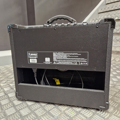 Pre-Owned Laney LG20R 20w Electric Guitar Combo A black L-Acoustic HP8000 speaker cabinet shown from the back, with the rear panel, handle, and internal wiring visible, placed on a diamond-plate metal surface.