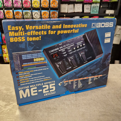 Pre-Owned Boss ME-25 Multi-Effects Pedal BOSS ME-25 (GT-2000) multi-effects guitar tone processor retail packaging box, photographed at an angle on a light-colored floor with store shelves visible in the background.