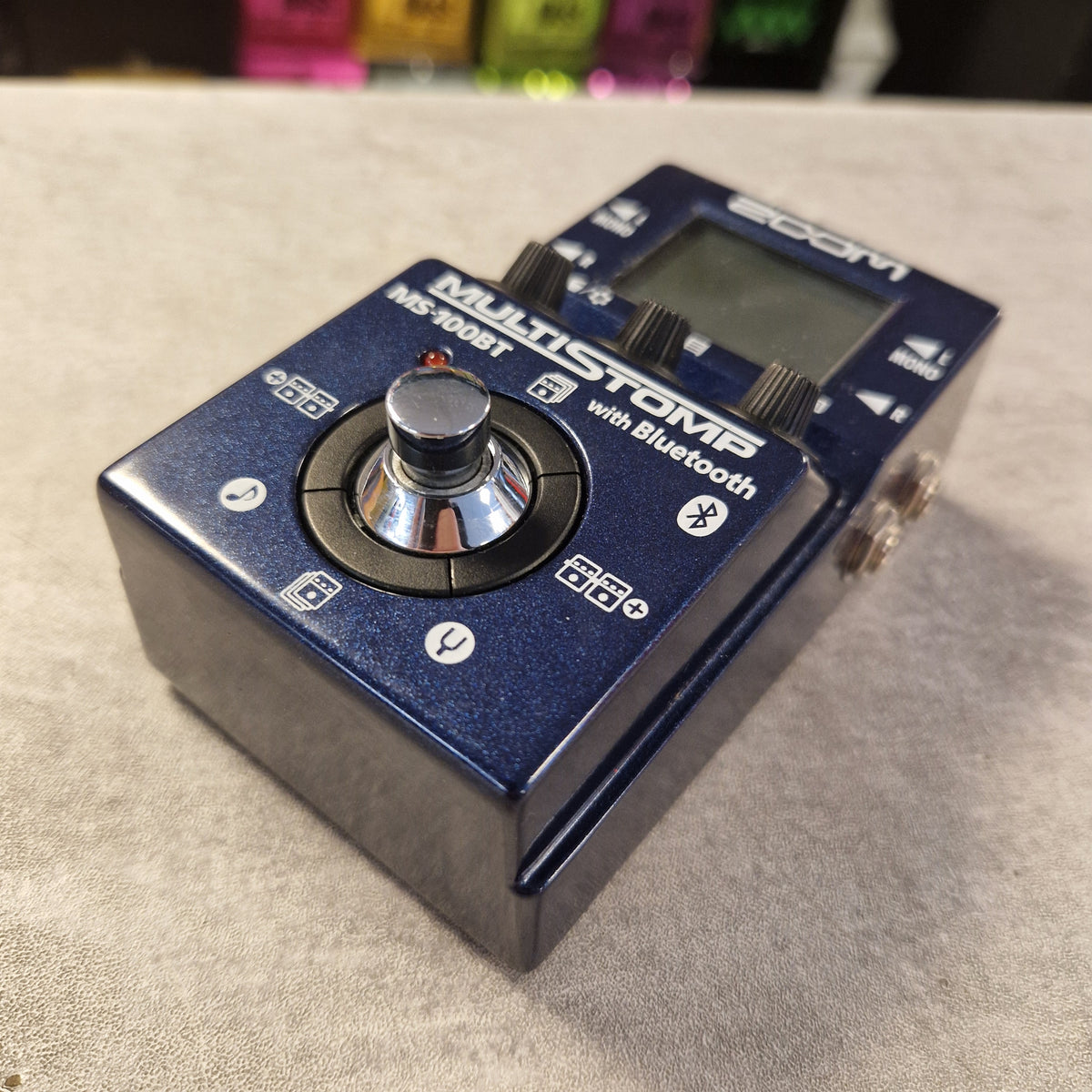 Pre-Owned Zoom MS-100BT MultiStomp Guitar Pedal with Bluetooth - A blue Marshall MB-300ST Multistomp with Bluetooth effect pedal, photographed at an angle on a textured light gray surface.