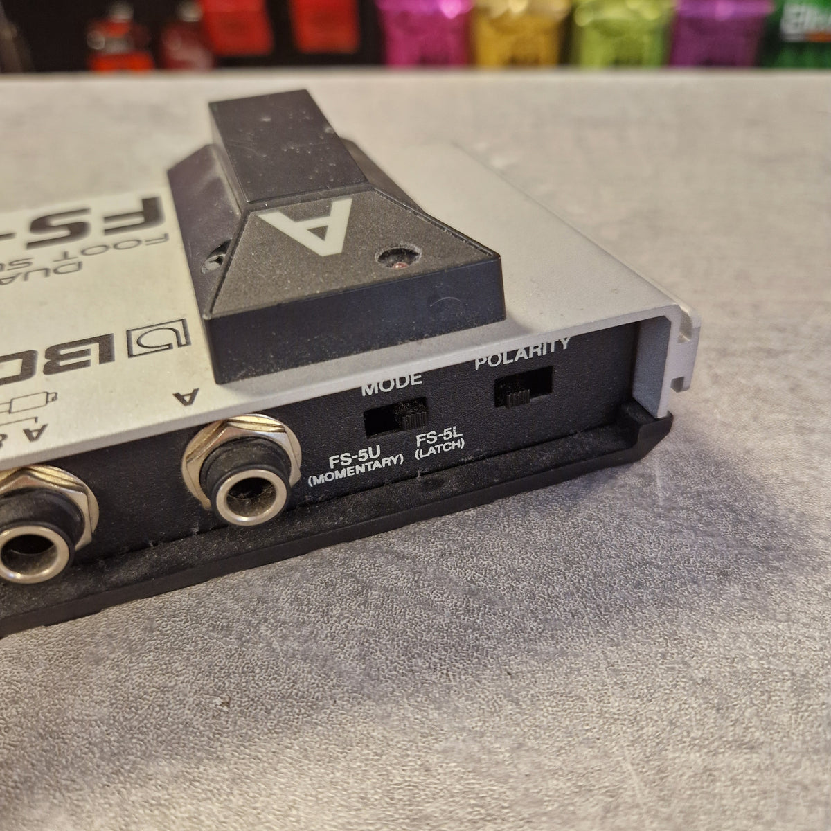 Pre-Owned Boss Dual Foot Switch FS-6 Pedal Close-up of the side and rear port panel of an Fostex F701 audio device, showing input jacks, polarity switch, mode switch, and branding on a gray textured surface.