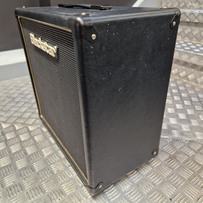 Pre-Owned Blackstar HT-112 1x12 Electric Amplifier Cab - A black Fender amplifier cabinet with a front grille and side view, resting on a diamond plate metal surface.