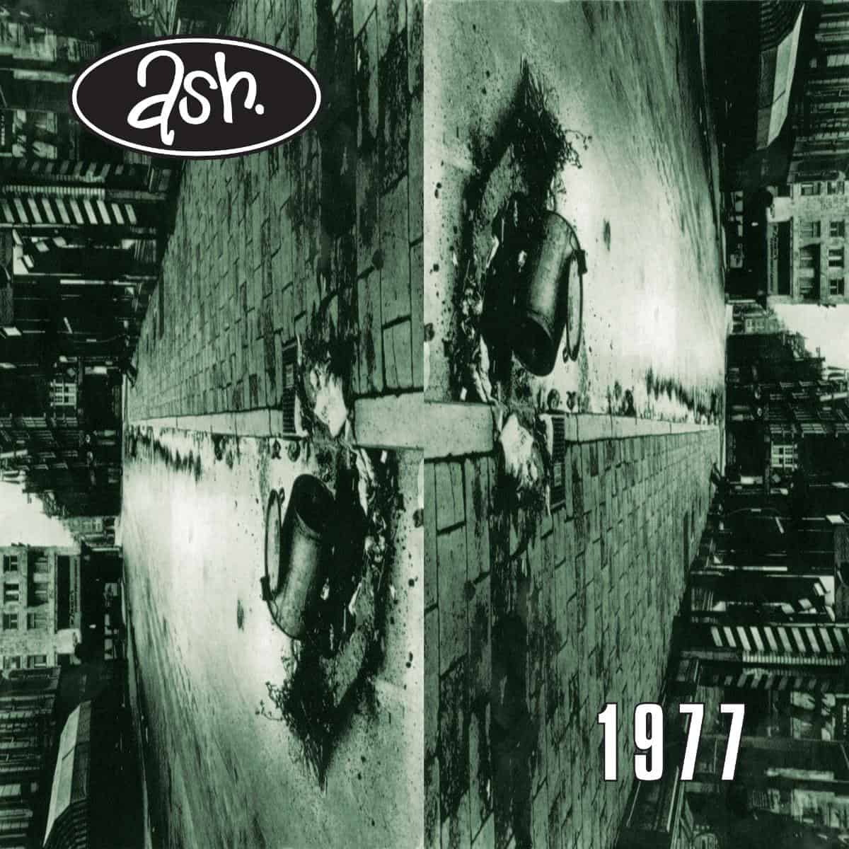 Ash - 1977 (30th Anniversary Edition Red) Vinyl Album cover with 'ash' logo and '1977' text, featuring a cityscape and large cylindrical object.