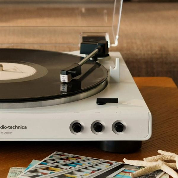 Audio-Technica ATN3600LC Record player with a vinyl record on a wooden surface