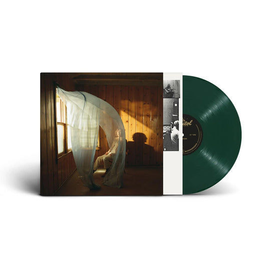 Beck - Ride Lonesome (Dark Green) Vinyl A vinyl record partially pulled from its sleeve, showing a dark green record and the album cover art with a seated figure in a warmly lit room.