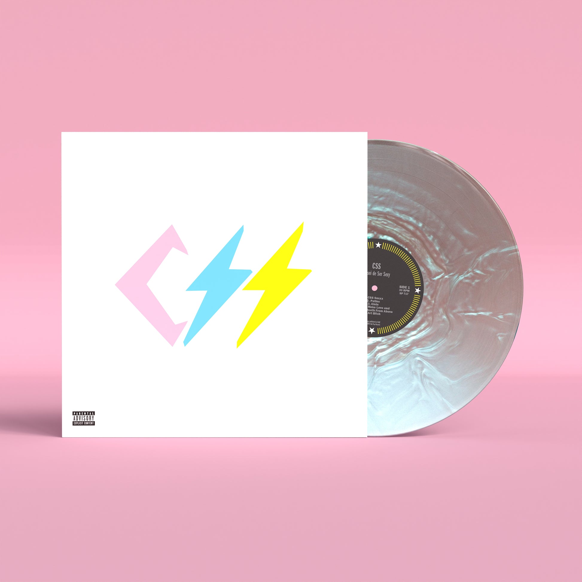 CSS - Cansei de Ser Sexy (20th Anniversary Edition Pearl Flip Waterfall) Vinyl A vinyl record partially pulled from its sleeve on a pink background. The sleeve is white with a pastel pink and yellow lightning-bolt logo, and the record itself is translucent iridescent with a black center label.