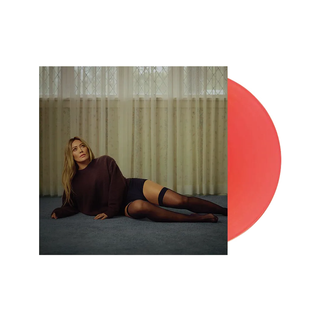 Hilary Duff Woman lying on the floor in a dark sweater and stockings with a red circle overlay.