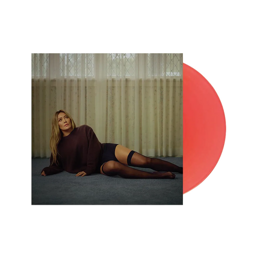 Hilary Duff Woman lying on the floor in a dark sweater and stockings with a red circle overlay.