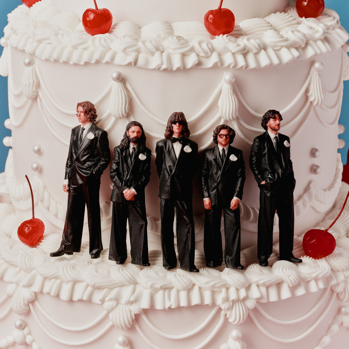 Blossoms - Songs From The Wedding Cake (Alt Artwork Splatter) Vinyl White wedding cake with five groom figurines and red cherries on a blue background