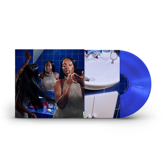 Rachel Chinouriri - I think I spoke too soon (Colour Ecorecord) Vinyl A vinyl record partially pulled from its sleeve, shown on a light gray background. The sleeve features a collage-style photograph with blue tiled walls, a woman brushing her teeth, and a sink, while the vinyl disc itself is a vivid translucent blue.