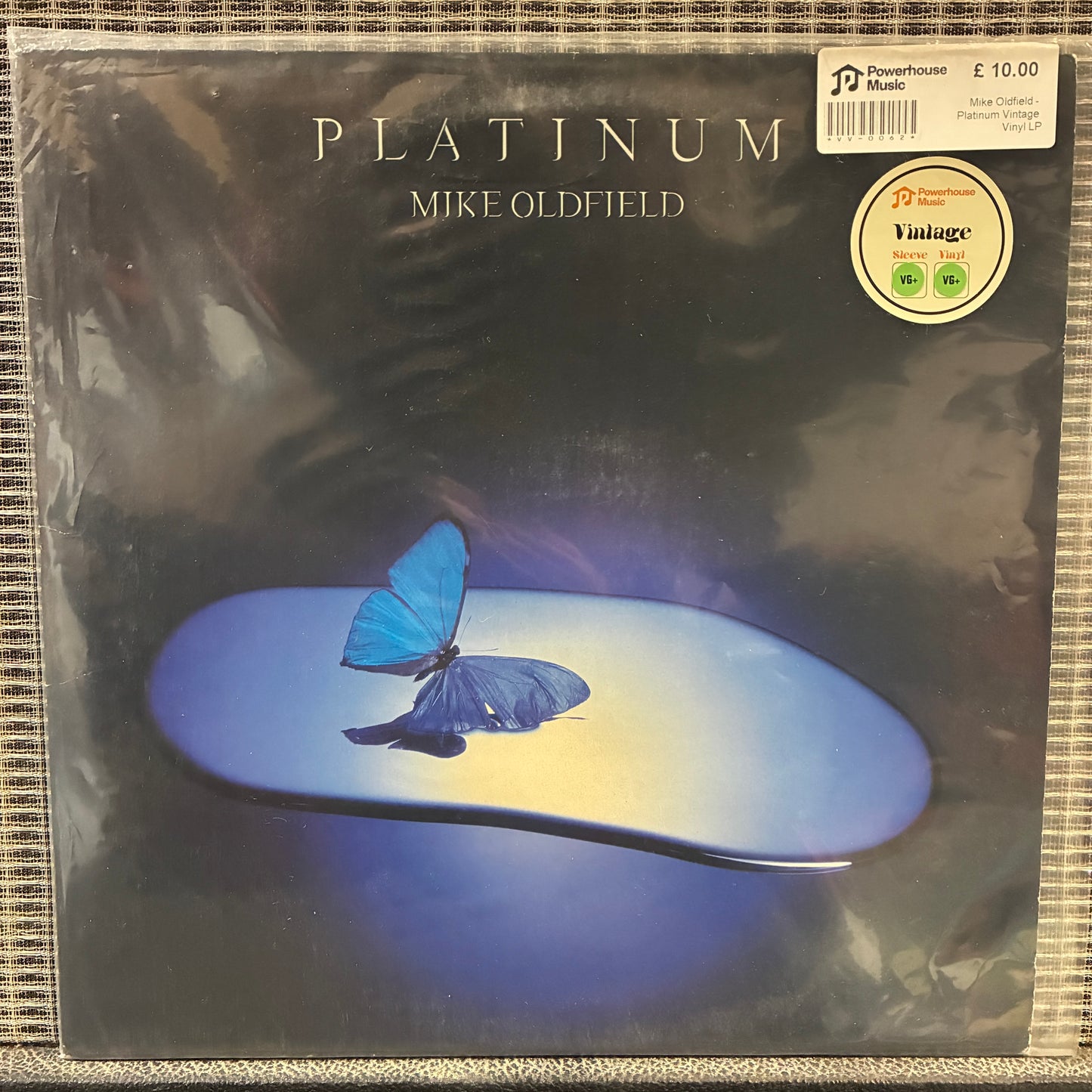 Mike Oldfield - Platinum Vinyl record cover with a blue butterfly on a dark background, featuring the text 'Platinum' and 'Mike Oldfield'.