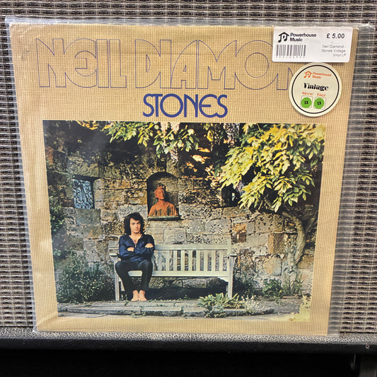 Neil Diamond - Stones Album cover of 'Noldamo Stones' with a person sitting on a bench in front of a stone wall.