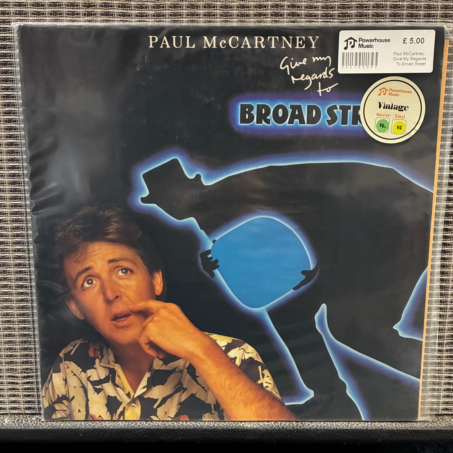 Paul McCartney - Give My Regards To Broad Street Vinyl record cover with a person and blue silhouette of a gun, featuring Paul McCartney's name.