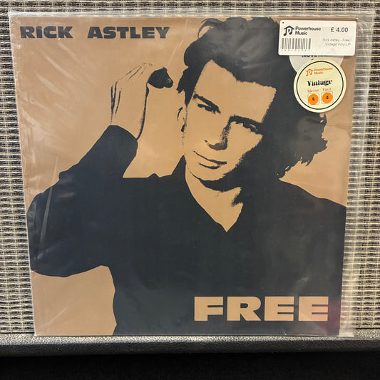 Rick Astley - Free Vinyl record cover with a portrait of a person and the word 'FREE' on a beige background