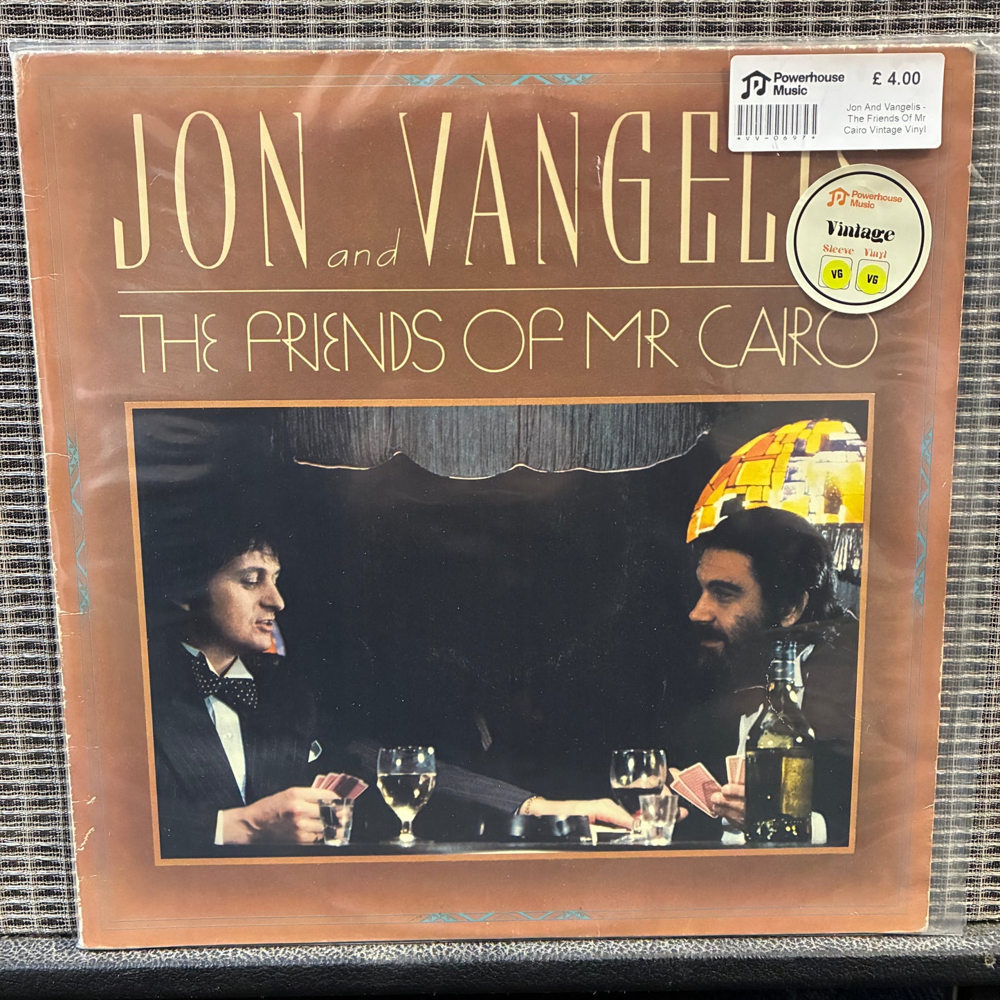 Jon And Vangelis - The Friends Of Mr Cairo Vinyl record cover featuring two people at a table with drinks, labeled 'Jon Vangel and the Friends of Mr. Cairo'.
