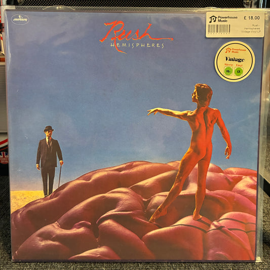 Rush - Hemispheres Vintage Vinyl LP Bush - Hemispheres vinyl record album in its original shrink wrap, featuring the iconic artwork of a standing nude figure on a fleshy landscape under a blue sky. A Powerhouse Music sticker is visible in the top right corner.