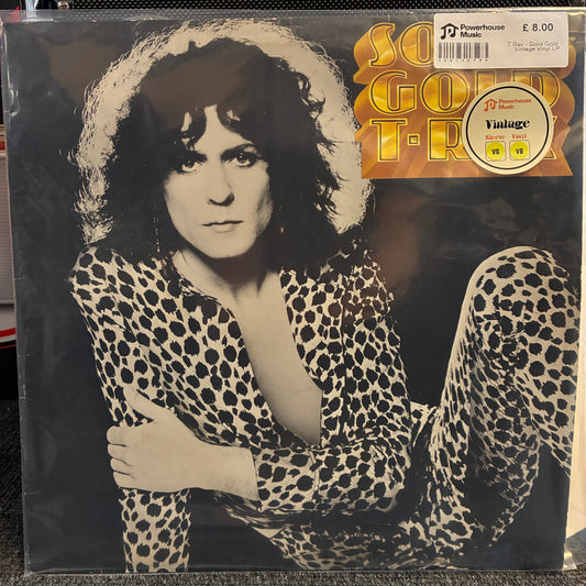 T. Rex - Solid Gold Vintage Vinyl LP A vinyl record sleeve for Soak Gold Tour featuring a black-and-white portrait of a woman in a leopard-print outfit, with a gold and orange tour title sticker and a Powerhouse Media Vintage sticker on the top right.