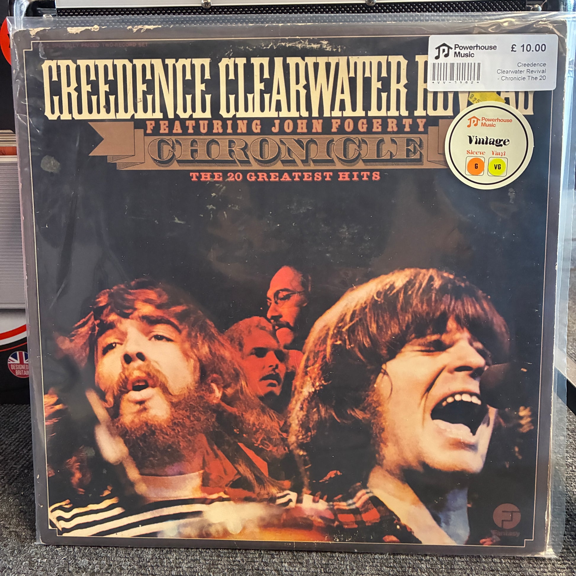 Creedence Clearwater Revival - Chronicle The 20 Greatest Hits Vintage Vinyl LP Creedence Clearwater Revival 'Chronicle: The 20 Greatest Hits' vinyl record album in its original shrink wrap, featuring John Fogerty. The cover art displays a dark background with the band members' faces in high-contrast color photography.