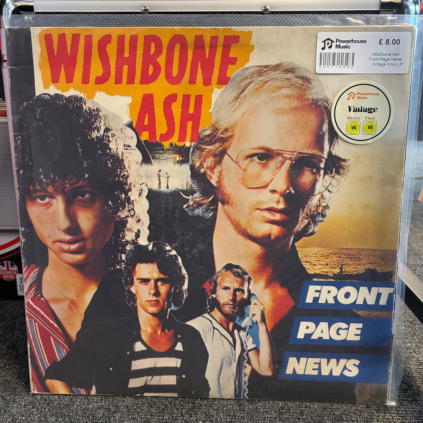 Wishbone Ash - Front Page News Vintage Vinyl LP A vintage Wishbone Ash single cover for 'Front Page News' on Powerhouse Records, sealed in a clear plastic protective sleeve. The cover features multiple portraits of the band members against a beach background, with bold red and yellow text, and a silver 'Vintage' sticker in the top right corner.