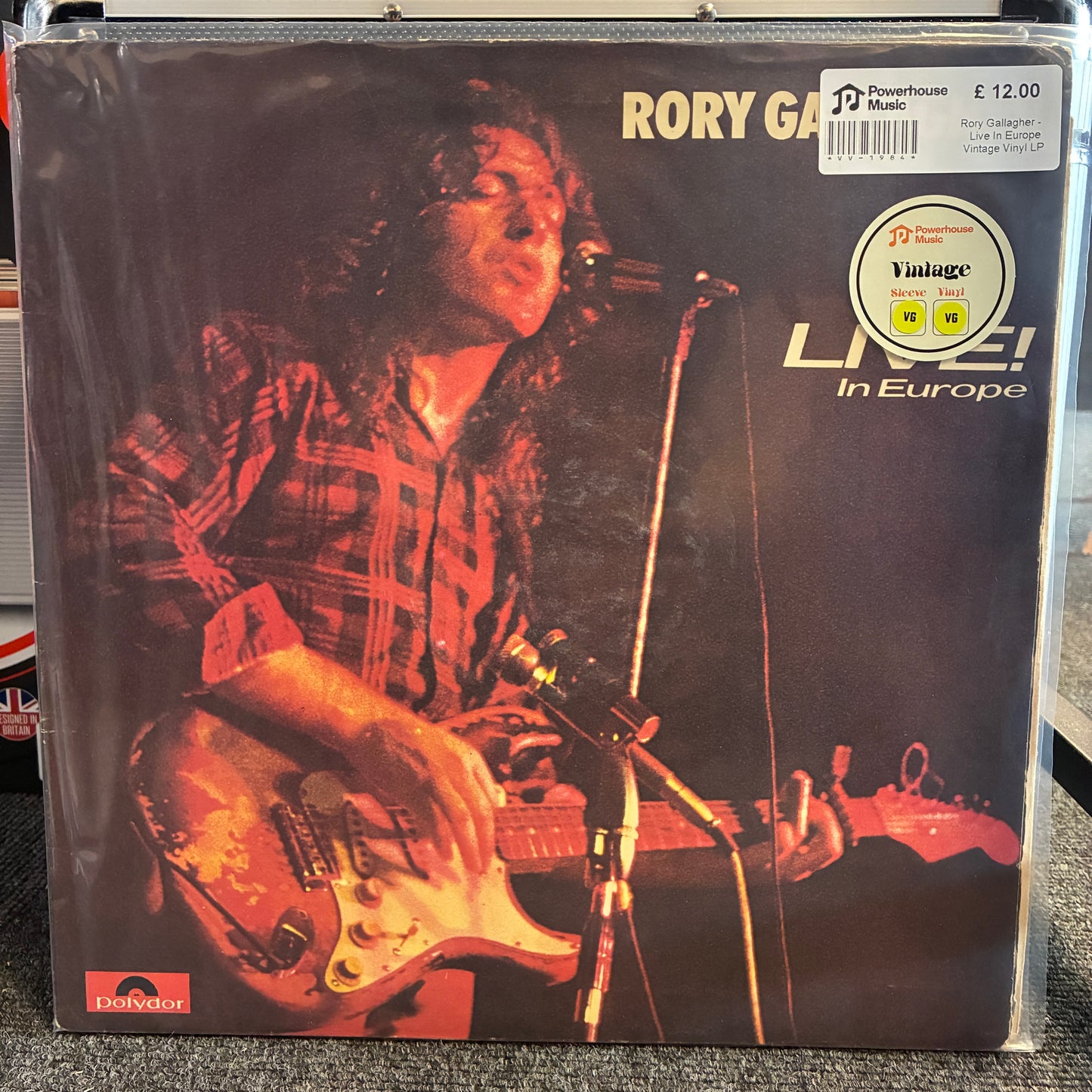 Rory Gallagher - Live In Europe Vintage Vinyl LP Rory Gallagher 'Live! In Europe' vinyl record album in its original shrink wrap, featuring a dark cover with a photo of Gallagher playing guitar and singing into a microphone.