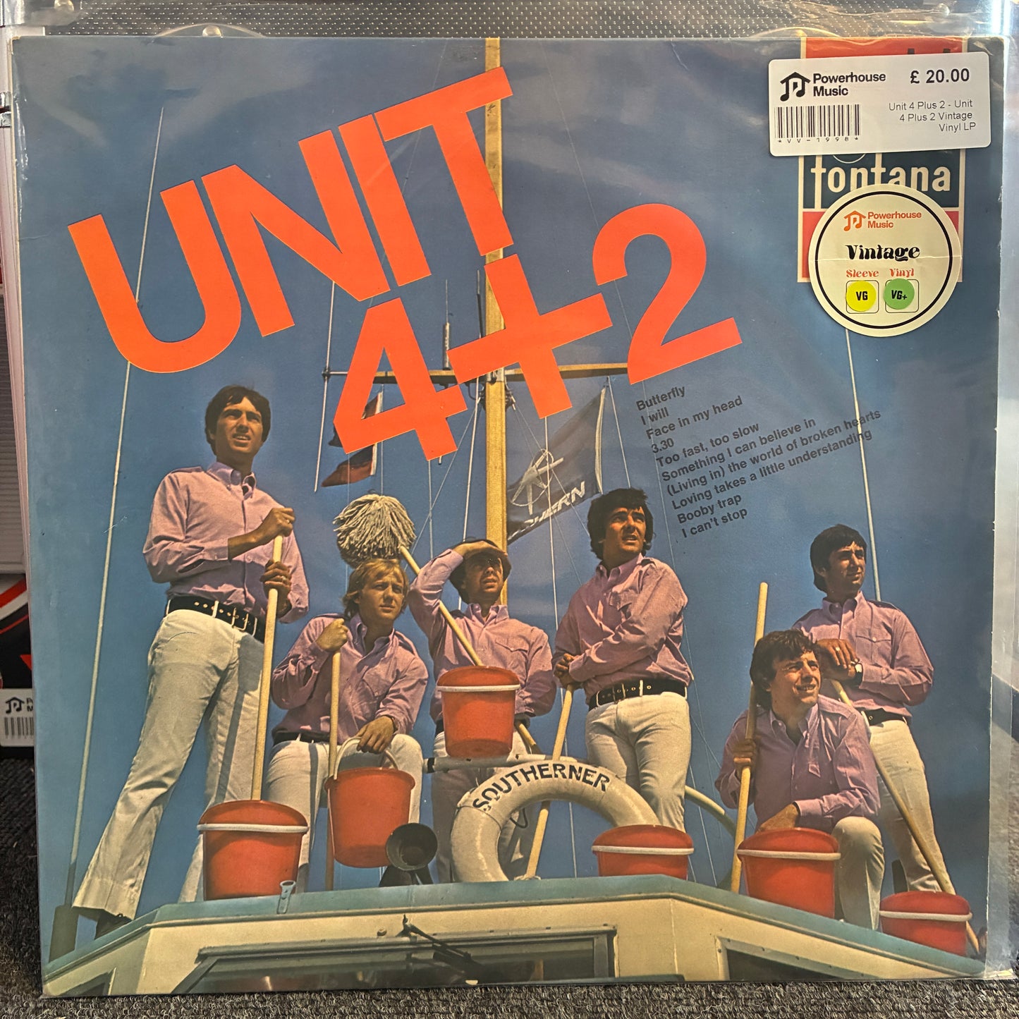 Unit 4 Plus 2 - Unit 4 Plus 2 Vintage Vinyl LP Vintage record sleeve for Fontana Vintage's 'Unit 4+2' featuring the band members on a boat deck against a blue sky background, with a barcode sticker and vinyl label in the top right.