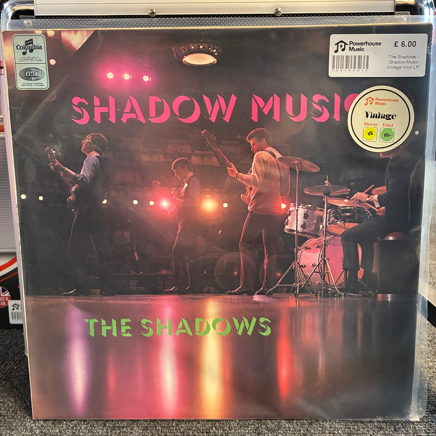 The Shadows - Shadow Music Vintage Vinyl LP The Shadows 'Shadow Music' vinyl record LP in a clear plastic protective case, featuring a stage performance photo with pink title text and a Powerhouse Records logo.