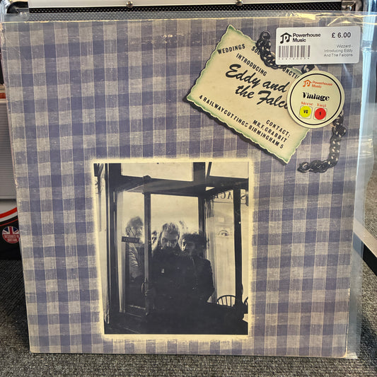 Wizzard - Introducing Eddy And The Falcons Vintage Vinyl LP A vinyl record sleeve for Eddy and the Fates' 'Weddings, Engagements and Affairs' on Powerhouse Records, featuring a blue and white gingham border and a black-and-white photograph of three people in a doorway, sealed in a clear plastic protective sleeve.